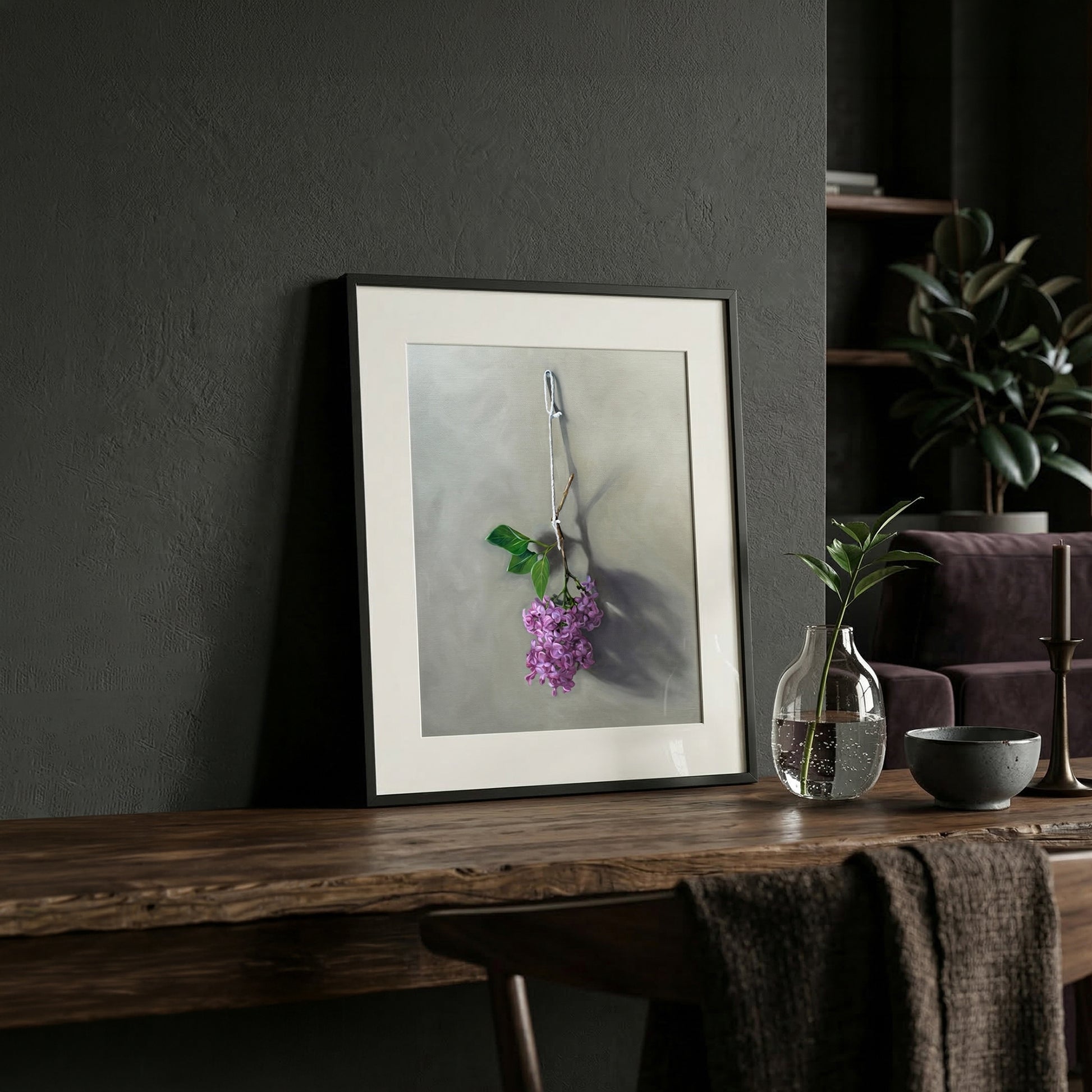 Framed fine art print of vibrant purple lilac blossoms hanging, displayed on a rustic wooden table.