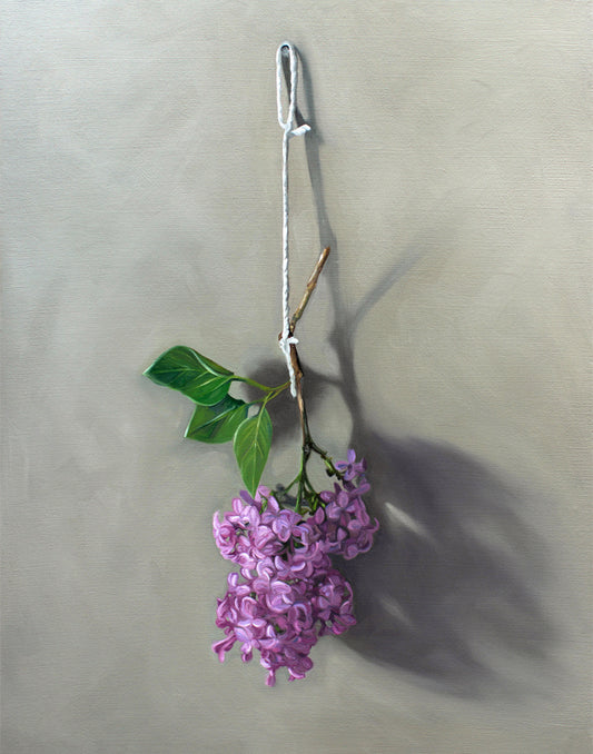 Vibrant fine art print of purple lilac blossoms and green leaves hanging from a white string on a neutral background.