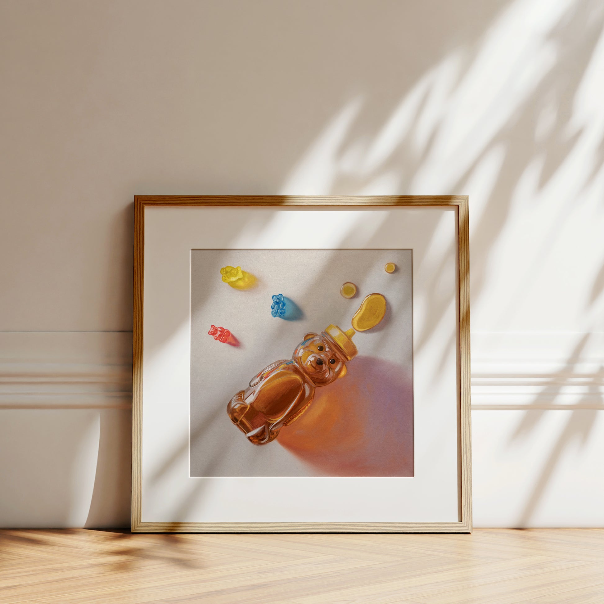 Framed fine art print of a honey bear bottle, honey, and colorful gummy bears on cotton rag paper.