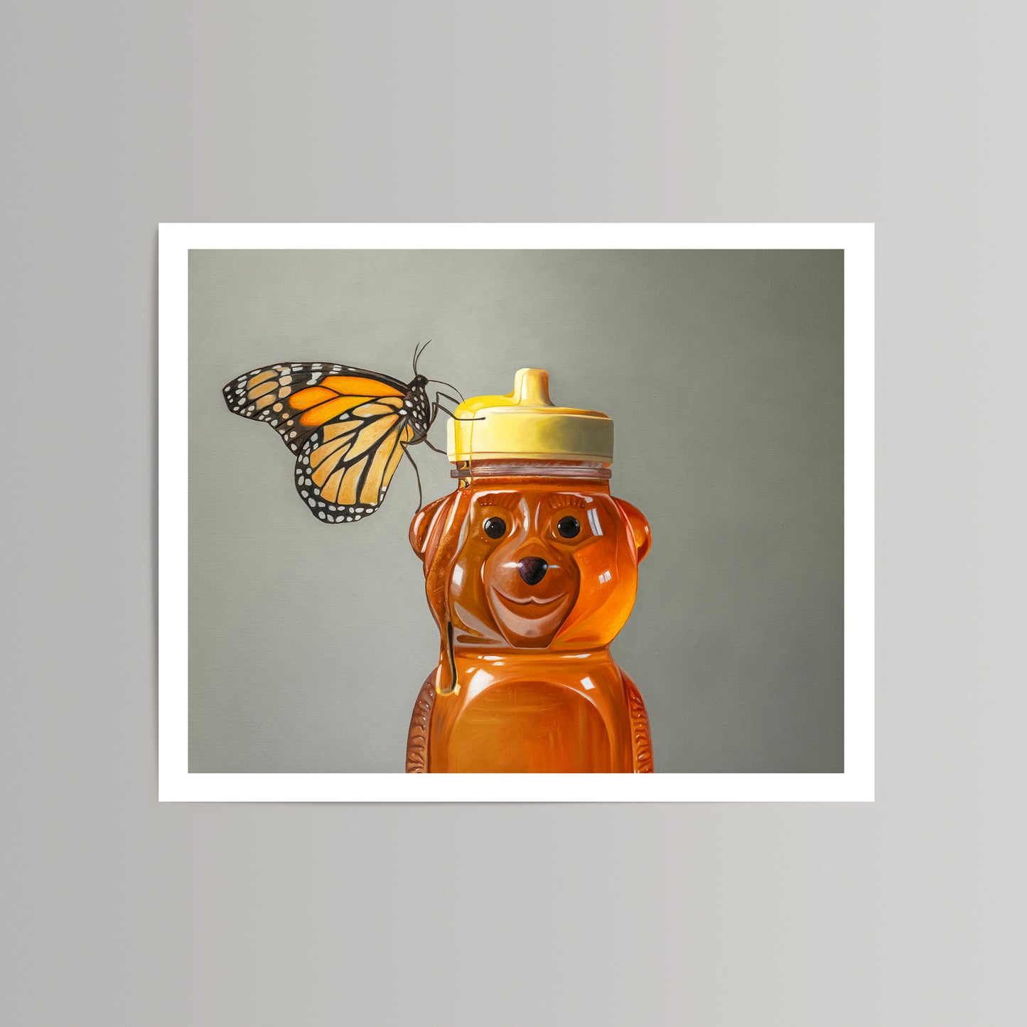 Fine art print of a vibrant monarch butterfly perched on a honey bear bottle with a yellow cap.