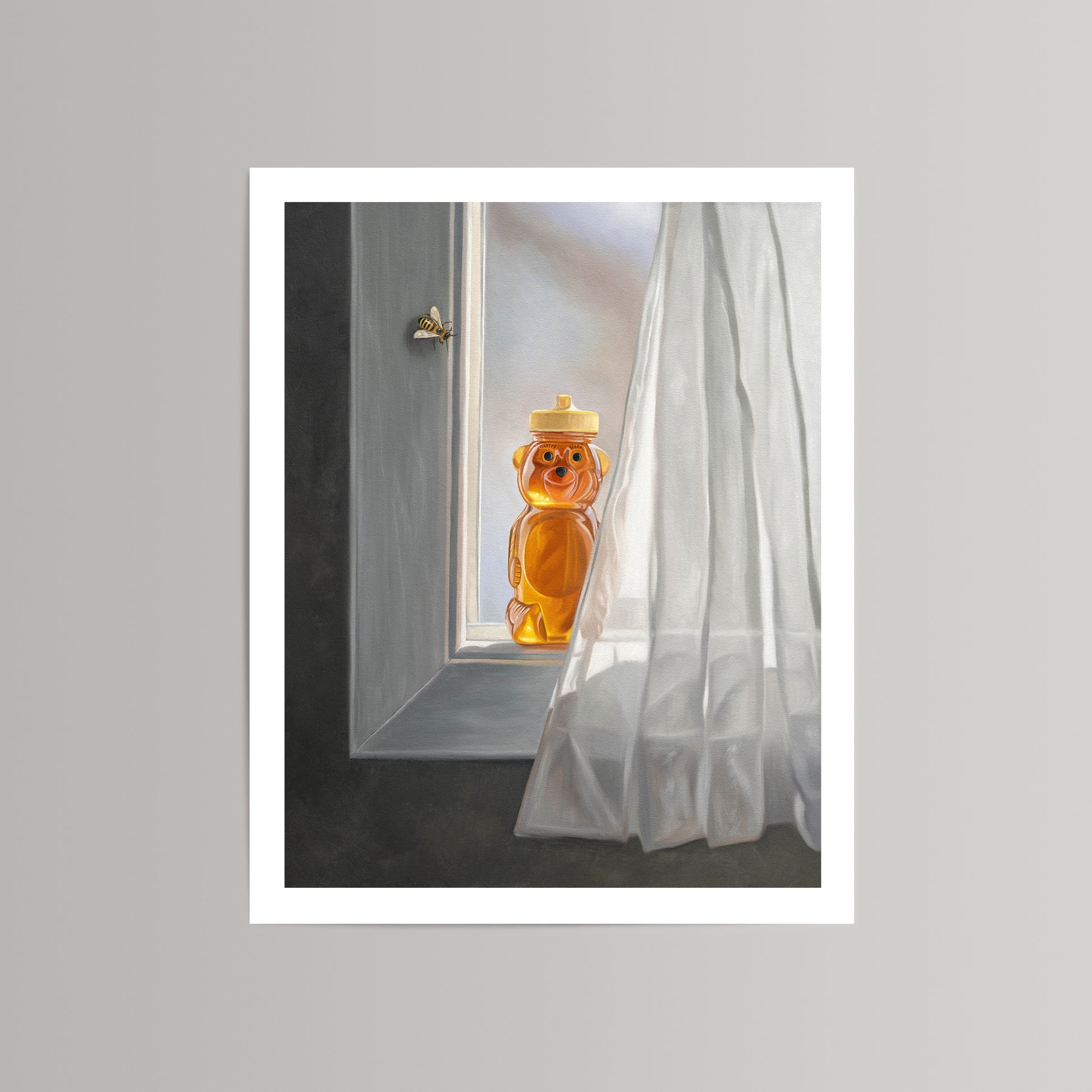 Fine art print of a honey bear jar on a sunlit window sill with a bee flying nearby and white curtain.