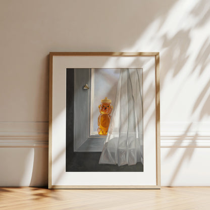 Framed fine art print of a honey bear jar and bee on a sunlit window sill with sheer white curtains.