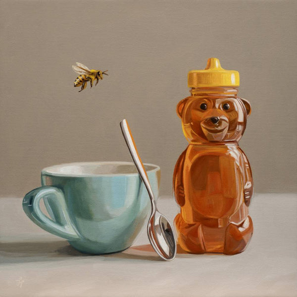 Honey bear bottle, teal mug, and spoon on a neutral background