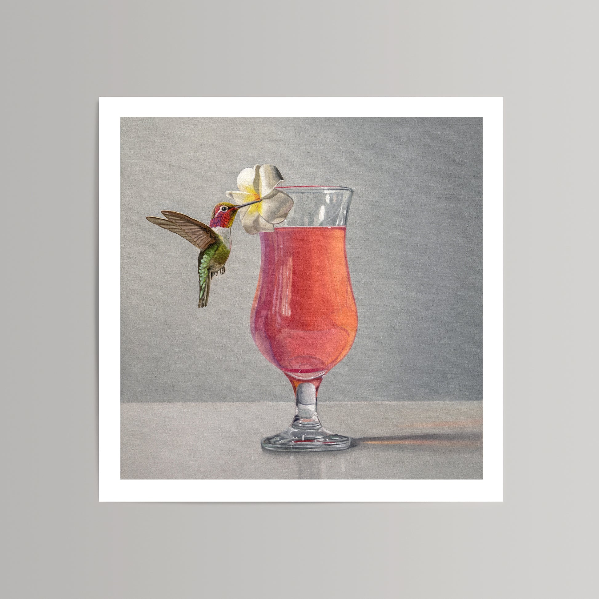 Fine art print of a hummingbird sipping from a pink cocktail garnished with a white plumeria flower.