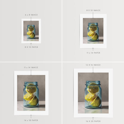Jar of Lemons Fine Art Print by Lauren Pretorius: a vintage turquoise jar containing a trio of lemon halves.