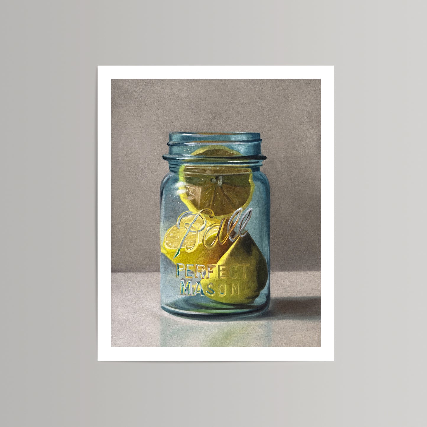 Vibrant fine art print of yellow lemon slices in a blue Ball Perfect Mason jar on a neutral background.