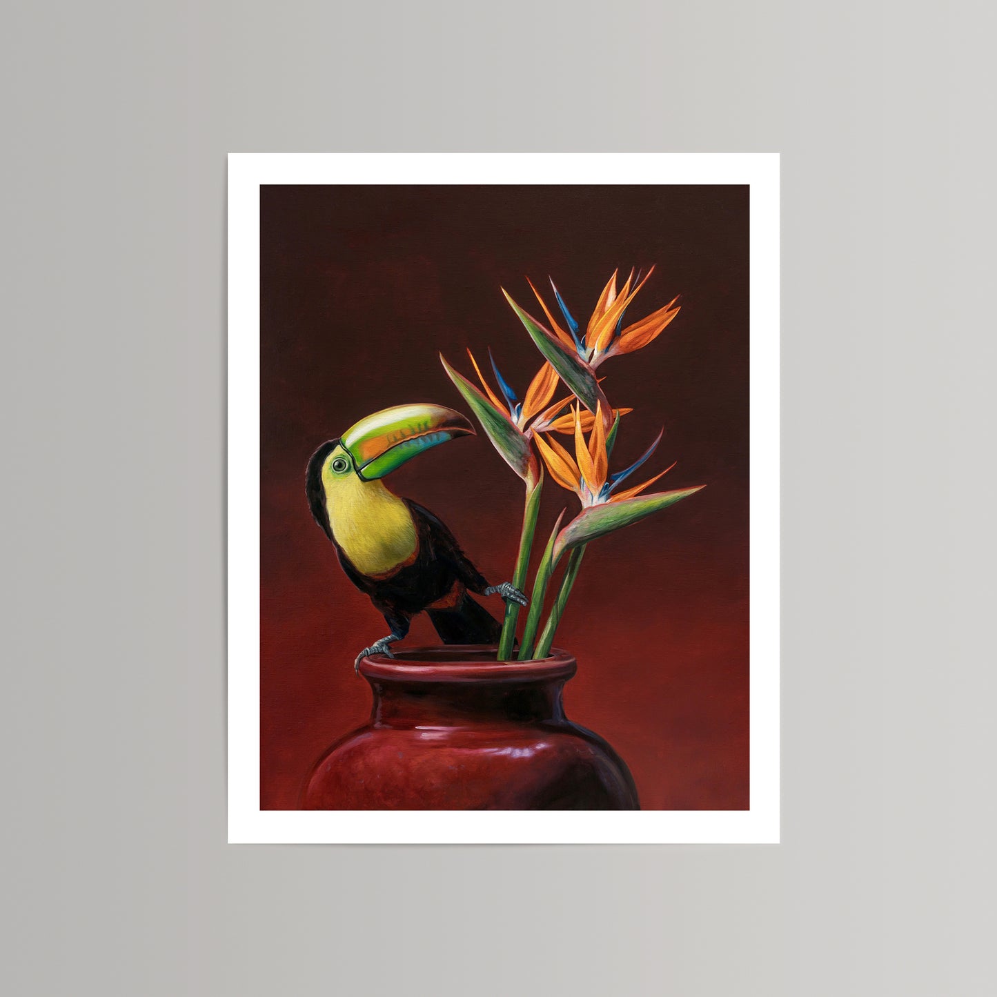 Vibrant fine art print of a Keel-billed Toucan perched on a red vase with orange Birds of Paradise flowers.