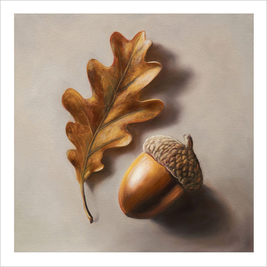Fine art print of a golden-brown oak leaf and acorn on textured cotton rag paper with a white border.