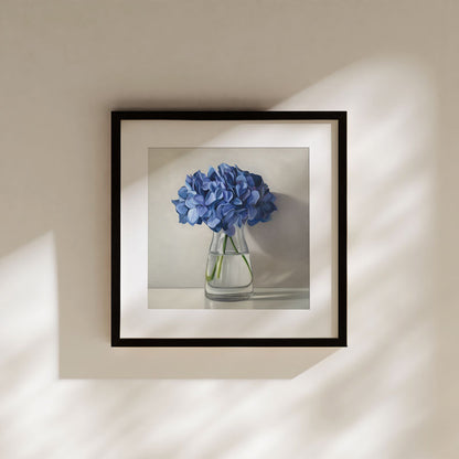 Framed fine art print of blue hydrangeas in a glass vase on museum-grade cotton rag paper with a white border.
