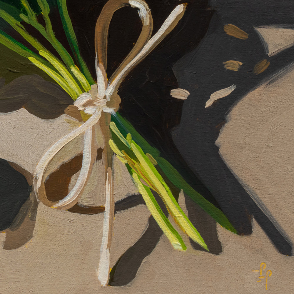 Bunch of green beans tied with a white ribbon on a textured surface