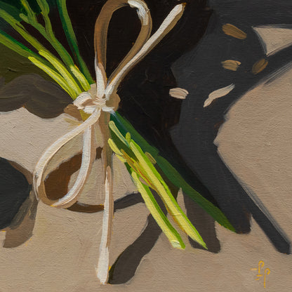 Bunch of green beans tied with a white ribbon on a textured surface