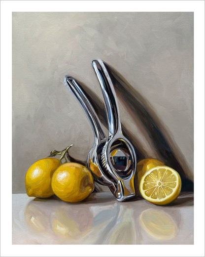 Fine art print of a shiny metal citrus press with bright yellow lemons on a neutral background with a white border.