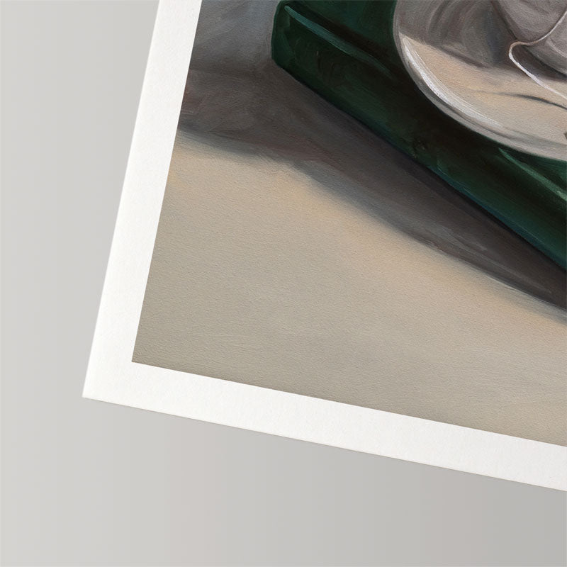Fine art print on textured cotton rag paper featuring a dark green book and a white teacup with a half-inch white border.