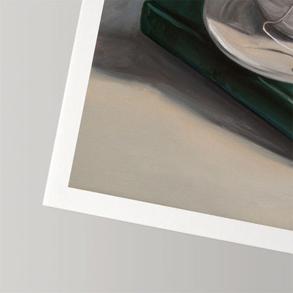 Fine art print on textured cotton rag paper featuring a dark green book and a white teacup with a half-inch white border.