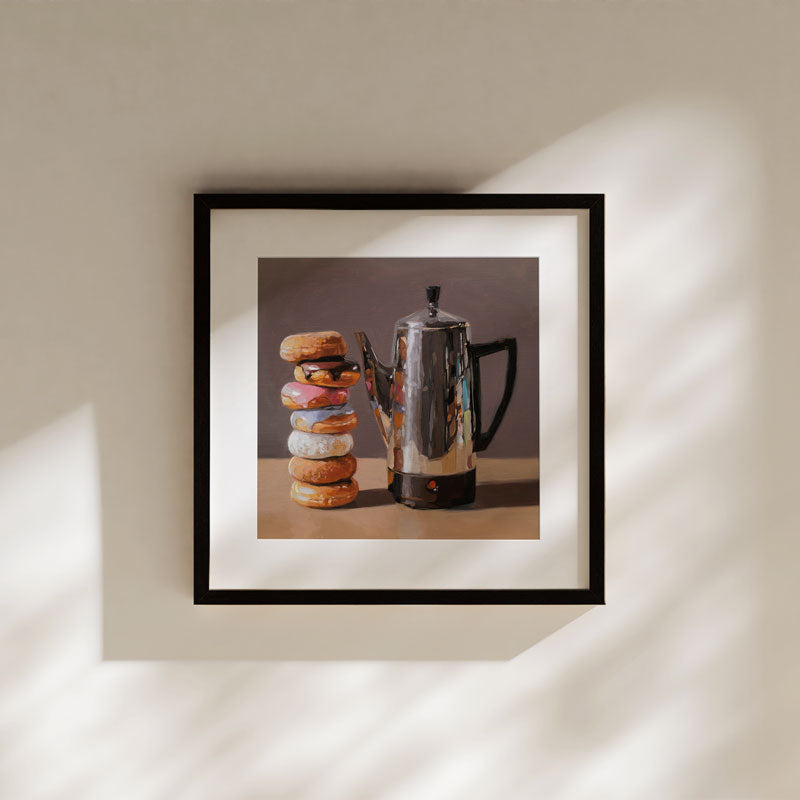 Framed fine art print featuring a stack of colorful glazed donuts next to a metallic coffee percolator.