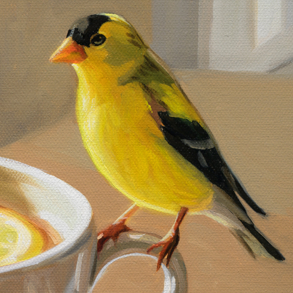 A painted goldfinch perched on the edge of a white mug, with a warm neutral background and visible canvas texture.