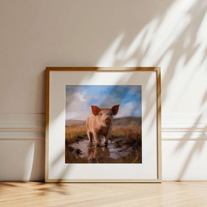 Fine art print of a pig in a muddy field, framed in light wood with a white mat, displayed against a neutral wall.