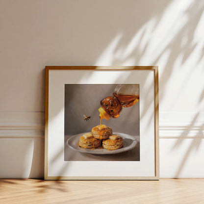 Framed fine art print of honey being poured over buttered biscuits with a bee, on museum-grade cotton rag paper.