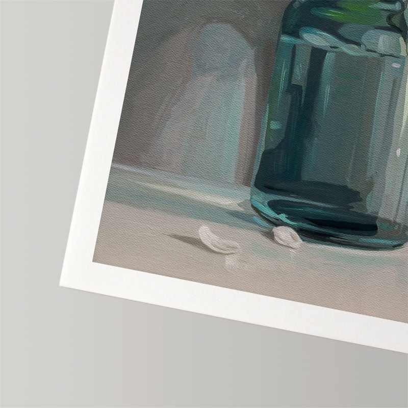 Fine art print of a teal glass jar with fallen apple blossoms on textured, museum-grade cotton rag paper with a white border.