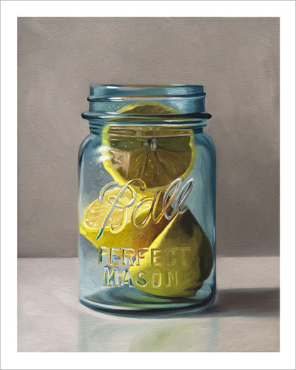 Fine art print of bright yellow lemons inside a vintage blue Ball mason jar on a neutral background with a white border.