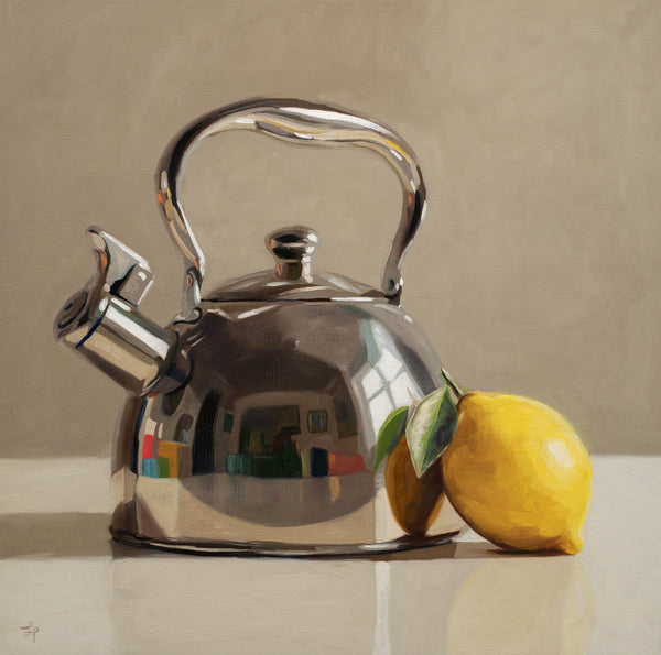 Silver kettle with a lemon on a reflective surface and beige background
