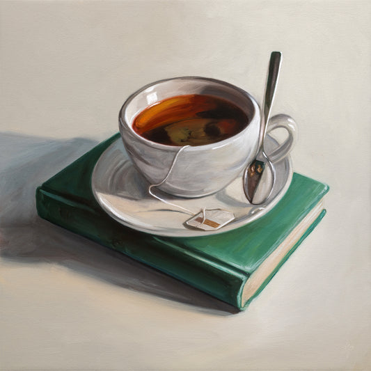 12x12 original oil painting of a porcelain teacup with a tea bag resting on a vintage turquoise book.