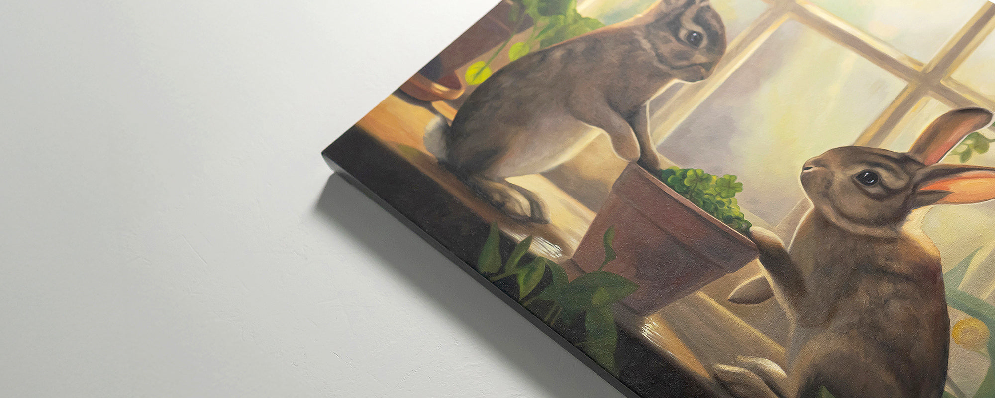 Original oil painting of two rabbits with a book on a white background by Lauren Pretorius