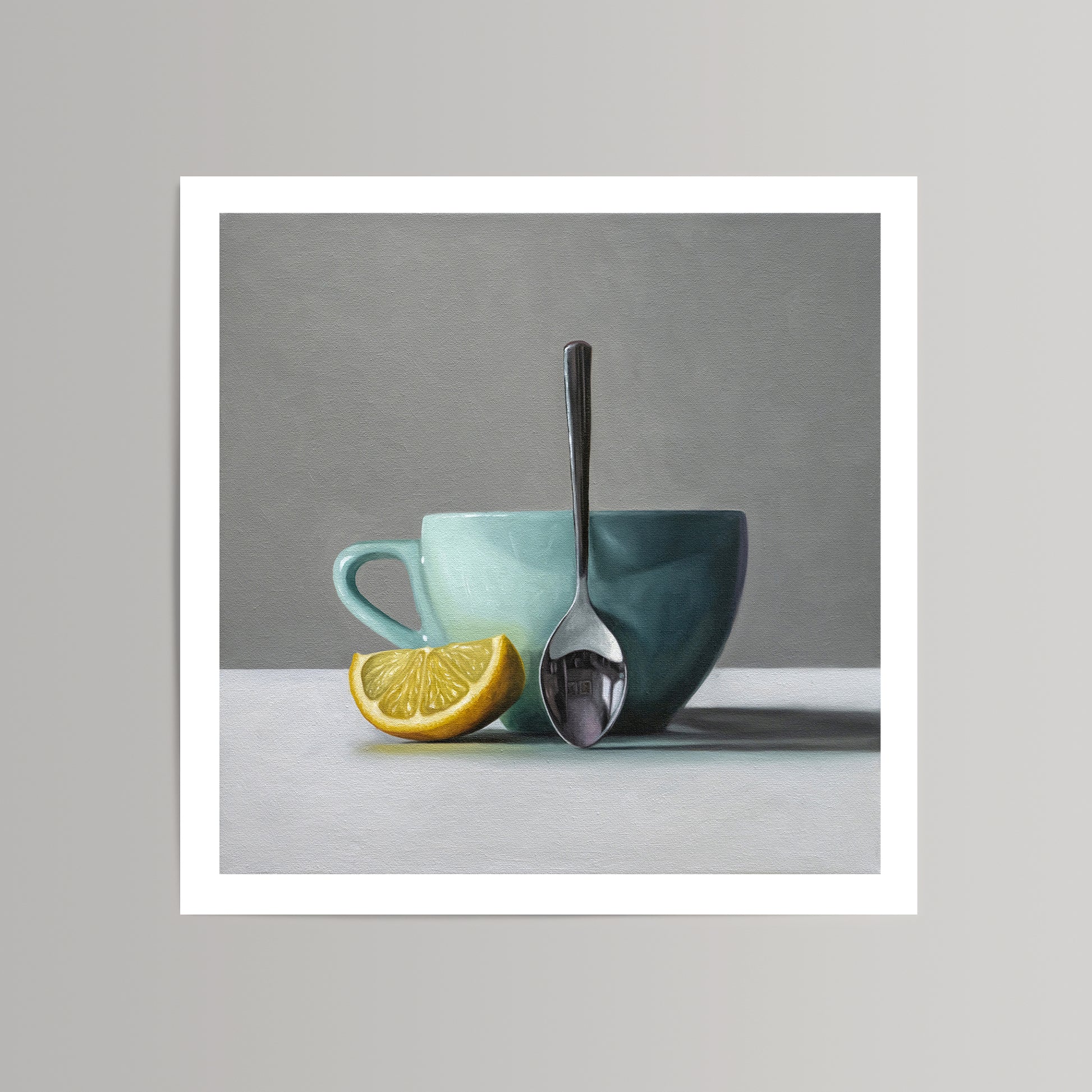 Still life art print: a vibrant lemon wedge, a teal cup, and a silver spoon on a white surface.
