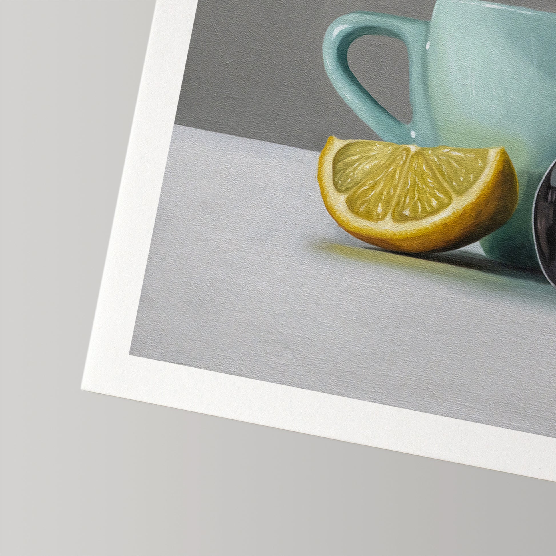 Still life art print of a vibrant yellow lemon wedge, a light blue cup, and a dark spoon.
