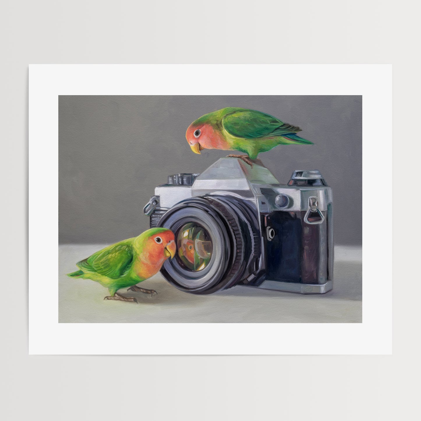 Lovebirds & Camera Fine Art Print by Lauren Pretorius: two lovebirds interacting with an old-fashioned camera on a neutral background