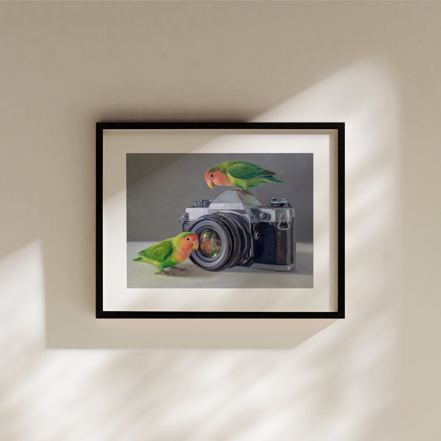 Lovebirds & Camera Fine Art Print by Lauren Pretorius: two lovebirds interacting with an old-fashioned camera on a neutral background