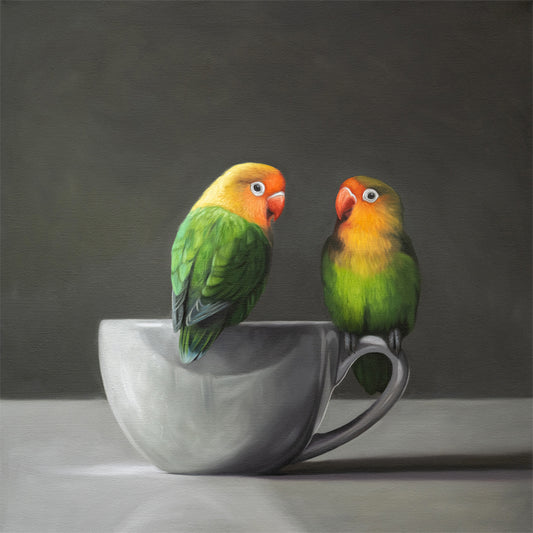 Fine art print of two vibrant green and orange lovebirds on a gray porcelain teacup.
