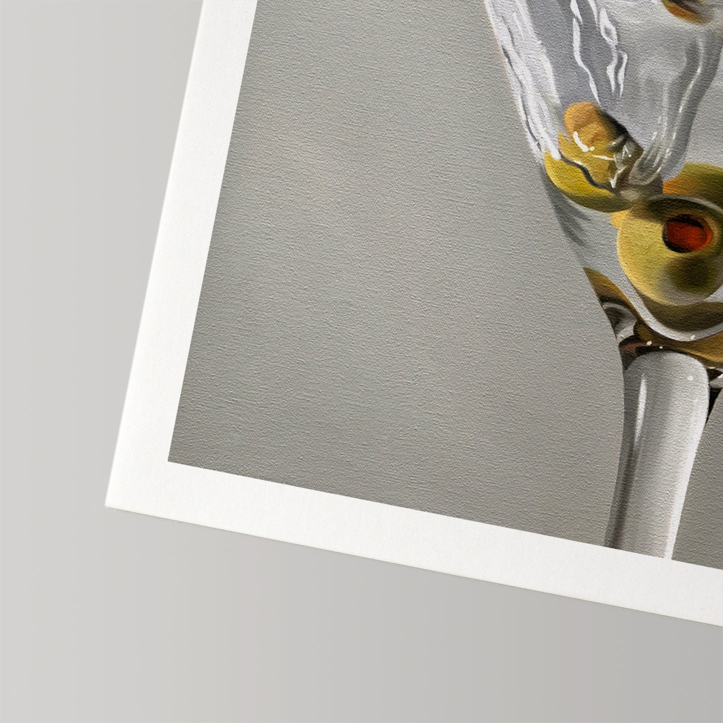 Close-up of a Martini Splash fine art print on cotton rag paper, showing a glass with green olives.