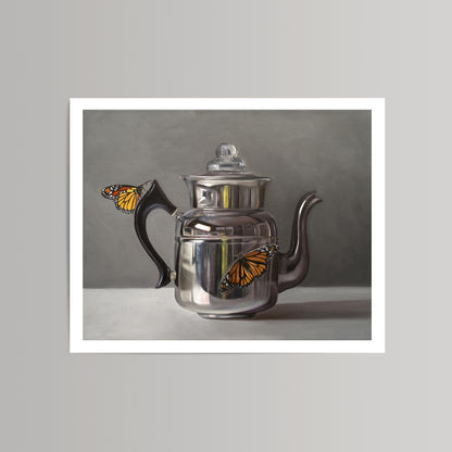 Fine art print of two vibrant orange monarch butterflies on a reflective silver kettle with a black handle.