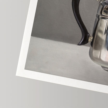 Fine art print of a silver kettle with a black handle, featuring a white border on museum-grade cotton rag paper.