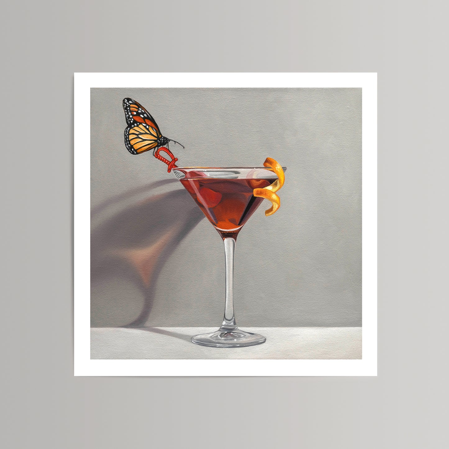 Fine art print of a monarch butterfly perched on a red high heel in a martini glass with an orange peel.