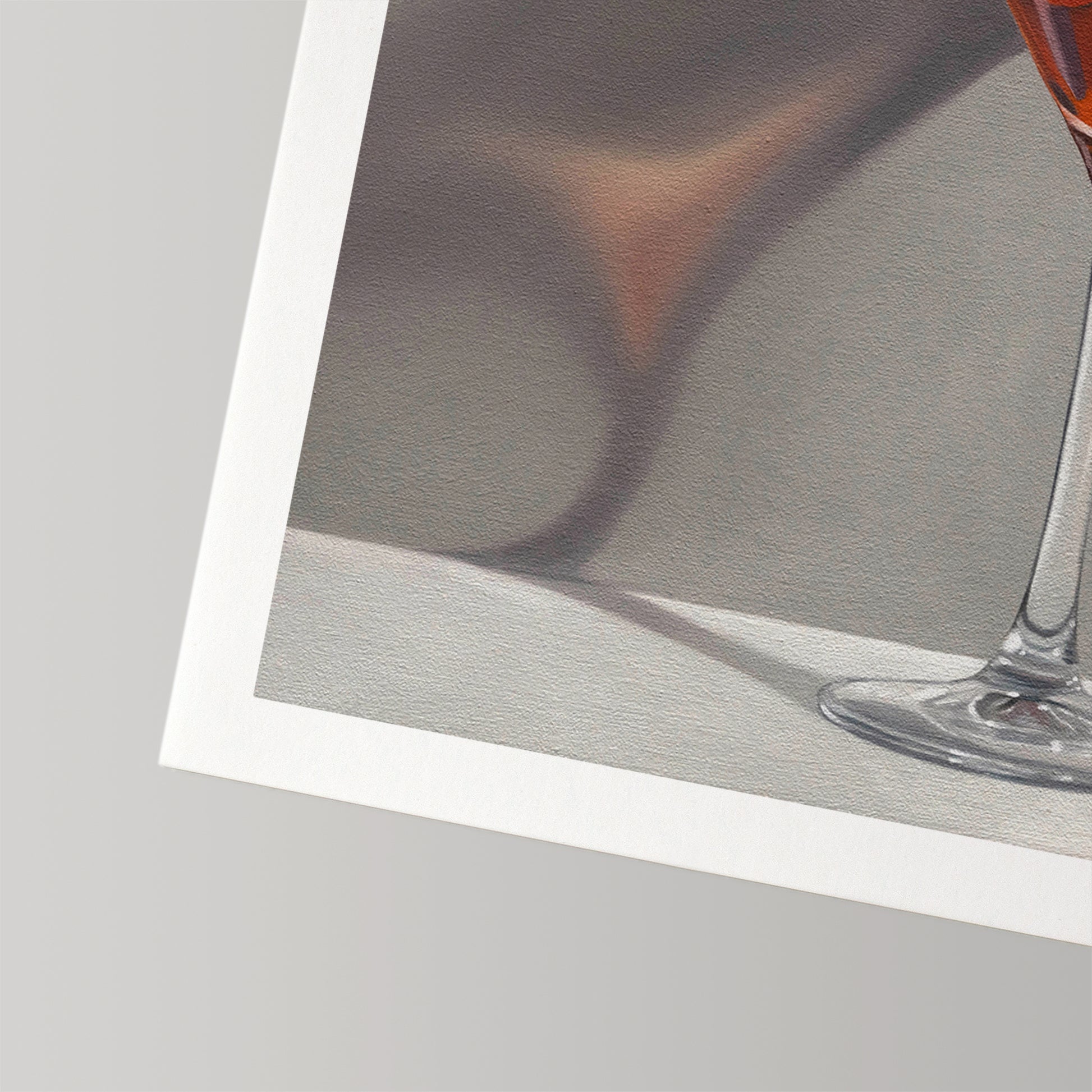Close-up of a fine art print on textured cotton rag paper, showing a glass with amber liquid and a white border.