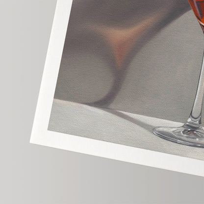 Close-up of a fine art print on textured cotton rag paper, showing a glass with amber liquid and a white border.