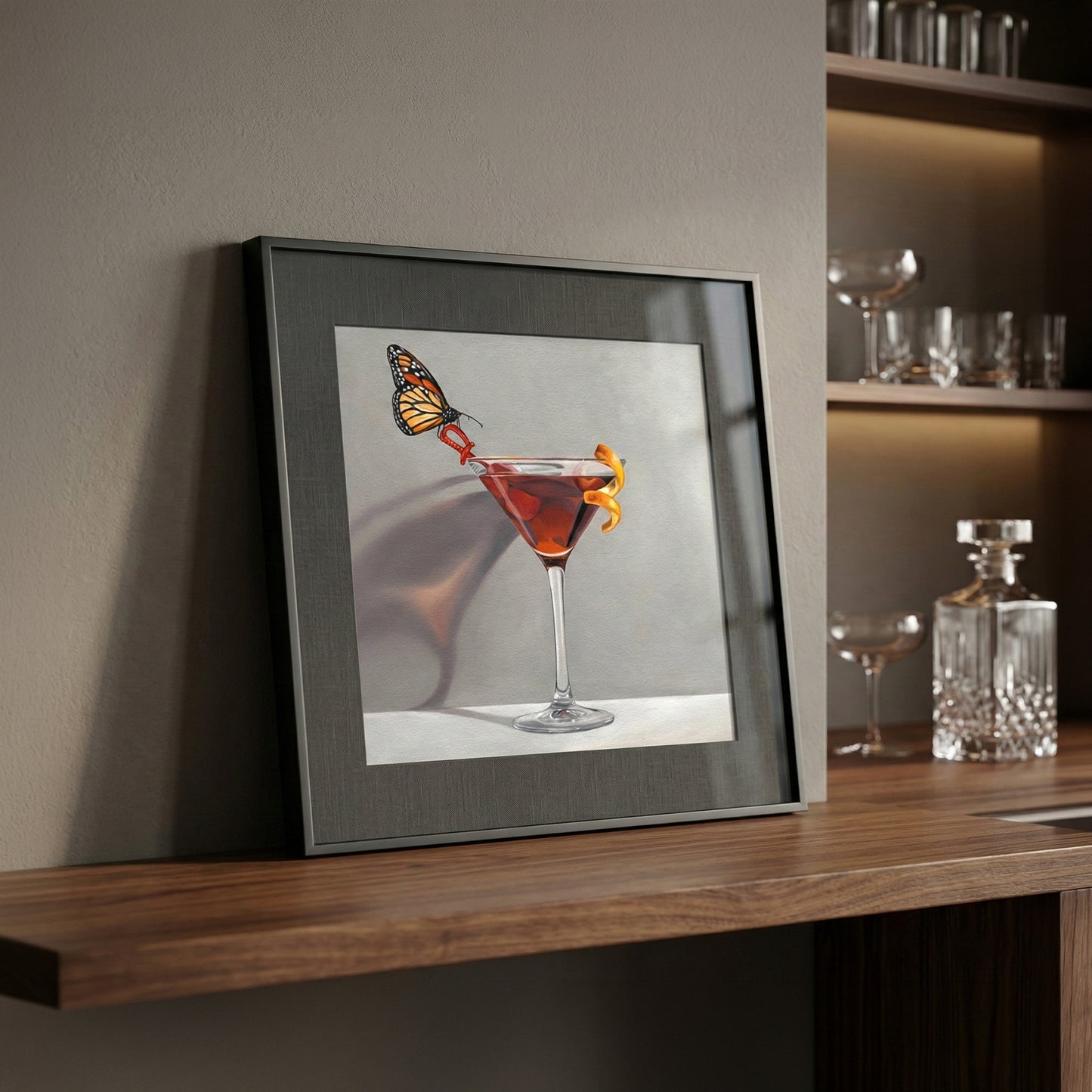 Framed fine art print of a monarch butterfly perched on a red cocktail in a martini glass.