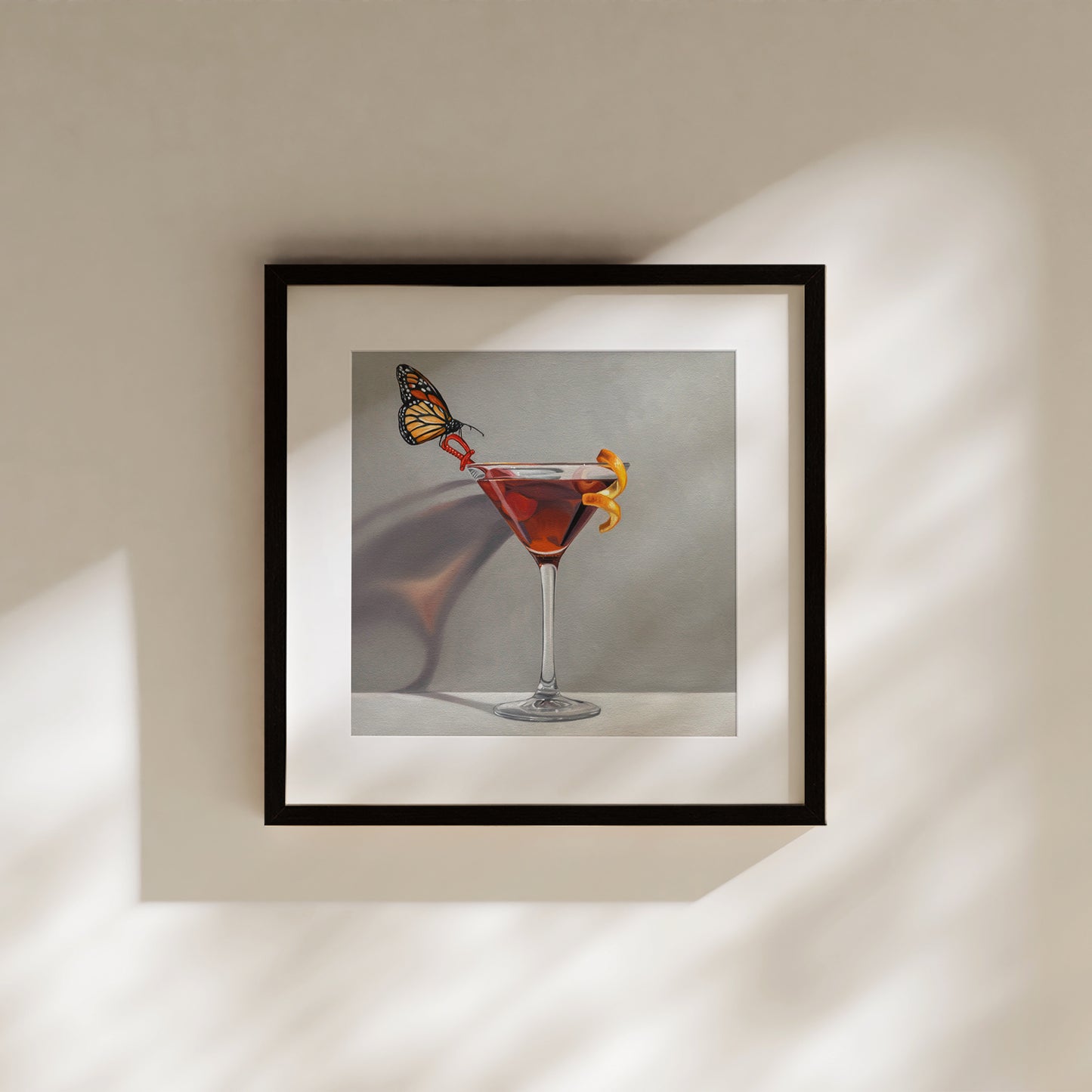 Monarch butterfly on a red cocktail in a martini glass, framed fine art print.