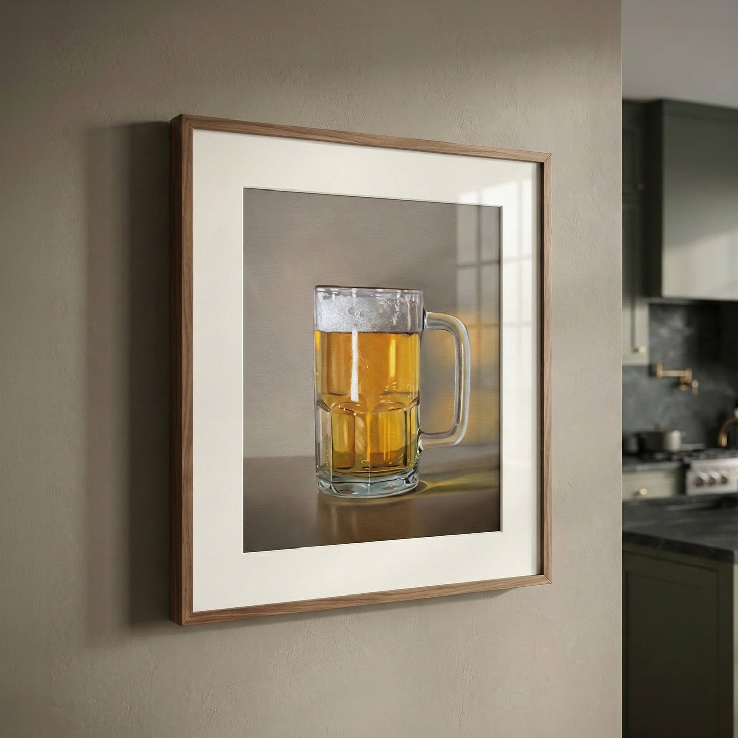 Framed fine art print of a frothy mug of golden beer, matted in a modern kitchen setting.