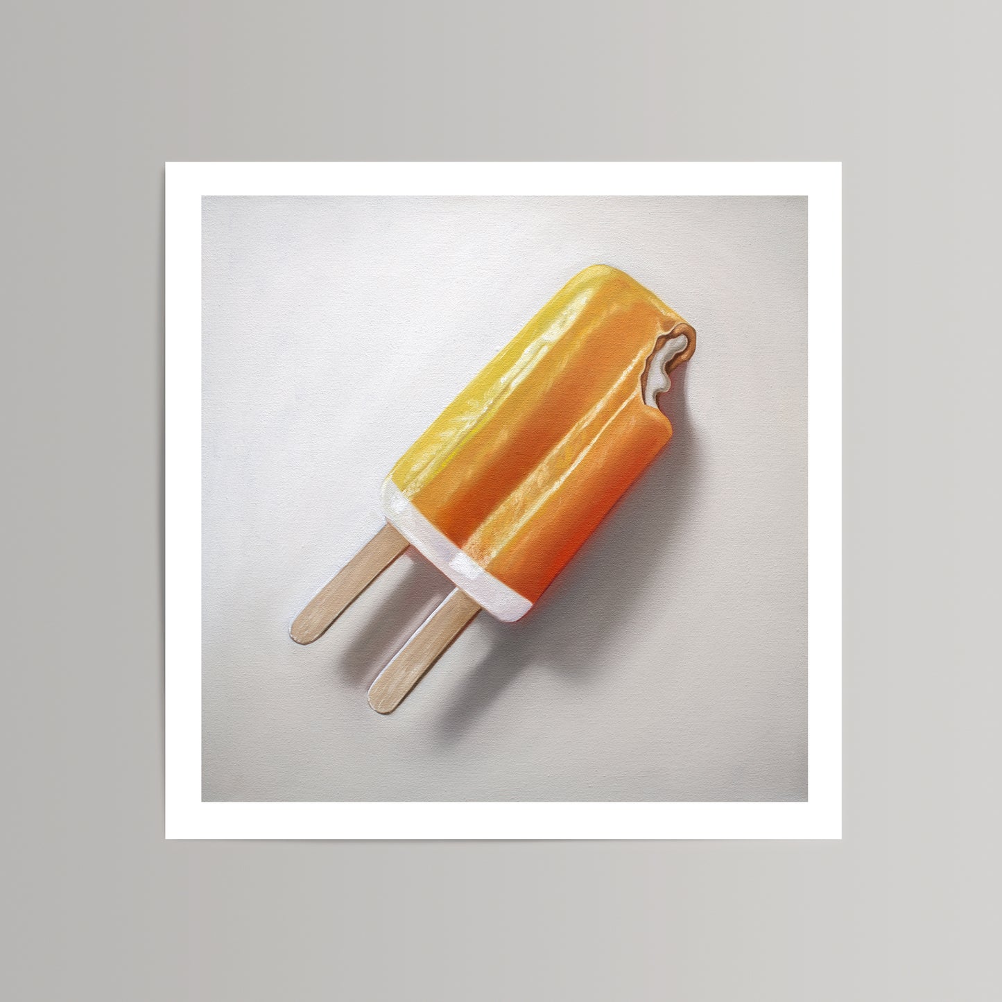 Vibrant fine art print of an orange dreamsicle with a bite taken, on museum-grade cotton rag paper.