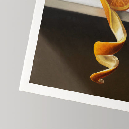 Fine art print of an orange peel twist and slice on dark background with a white border.