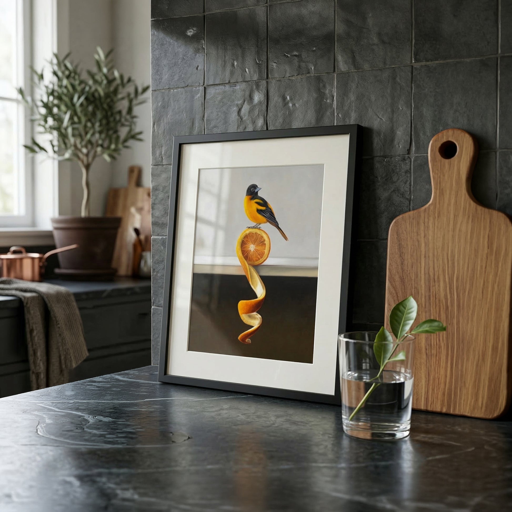 Framed "Orange Twist Oriole" fine art print featuring a vibrant orange and black bird on an orange peel.