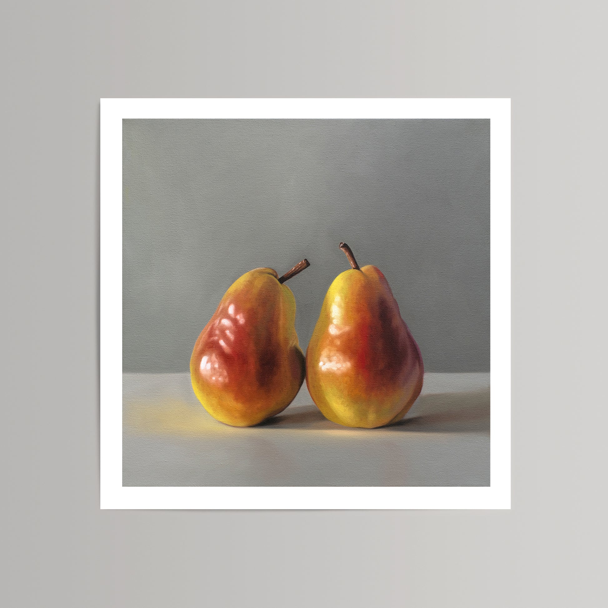 Realistic fine art print of two yellow and red pears on a light surface against a gray background.