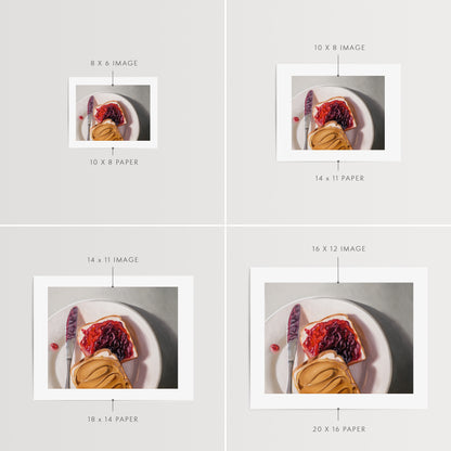 Peanut Butter and Jelly Sandwich Fine Art Print by Lauren Pretorius: a peanut butter and jelly sandwich, depicted with oil paints on a white plate with a knife and a dollop of peanut butter visible.
