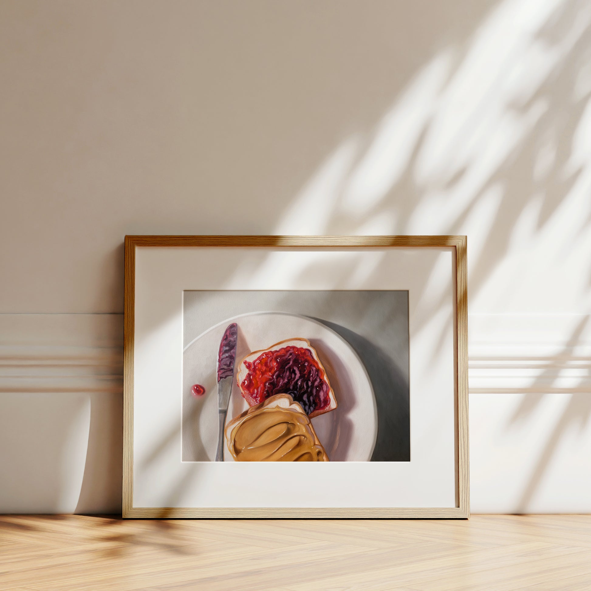 Peanut Butter and Jelly Sandwich Fine Art Print by Lauren Pretorius: a peanut butter and jelly sandwich, depicted with oil paints on a white plate with a knife and a dollop of peanut butter visible.
