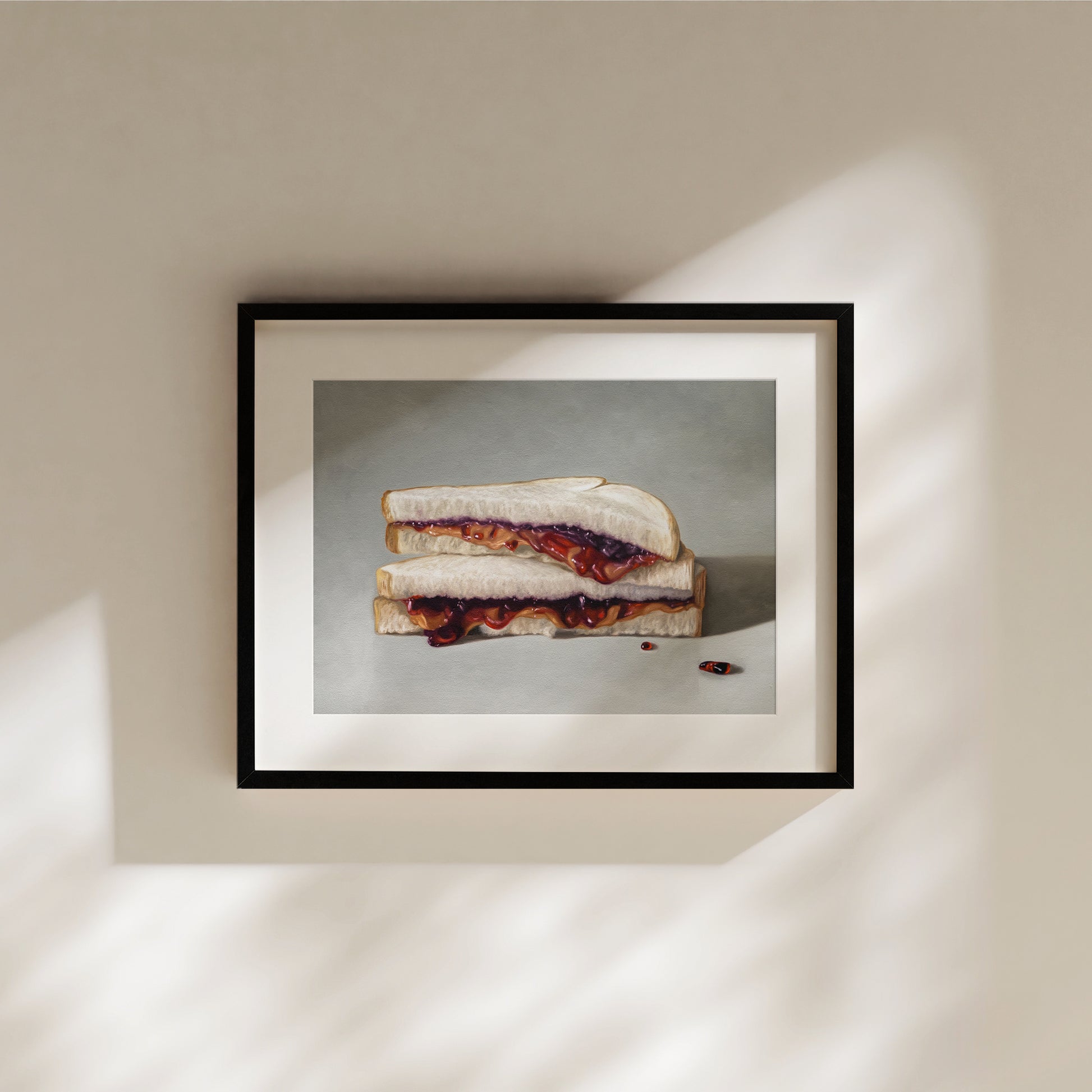 Framed fine art print of a peanut butter and jelly sandwich with two red pills on a light background.