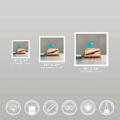 Three square art prints of a peanut butter and jelly sandwich with a blue umbrella, shown in various sizes.