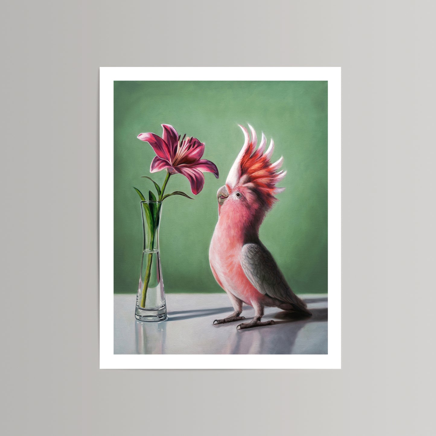Fine art print of a pink cockatoo admiring a deep pink lily in a clear vase against a green background.